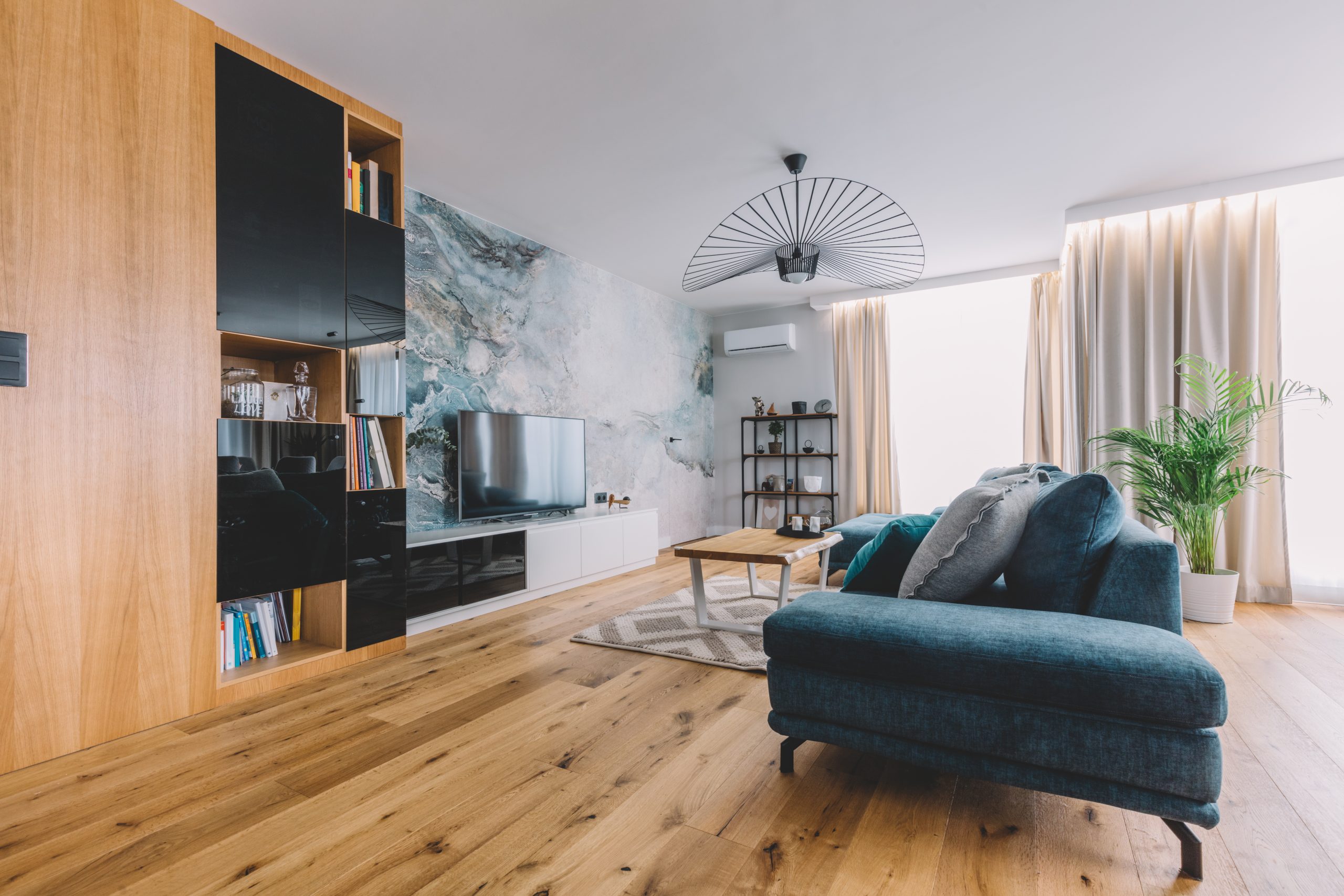 Open space living room with a big couch in a modern apartment.